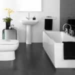 Black and white bathroom with a combination of matte stucco and glossy tiles