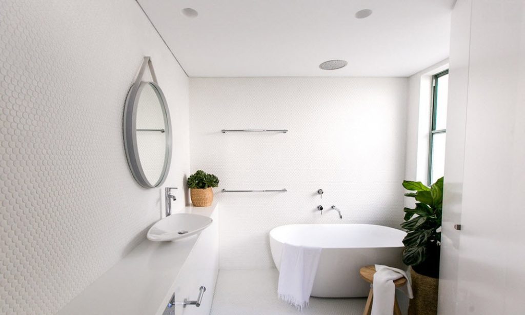 The white bathroom is beautiful and functional.