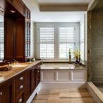 Bathroom in a private house cabinet with washbasin bathtub and shower area