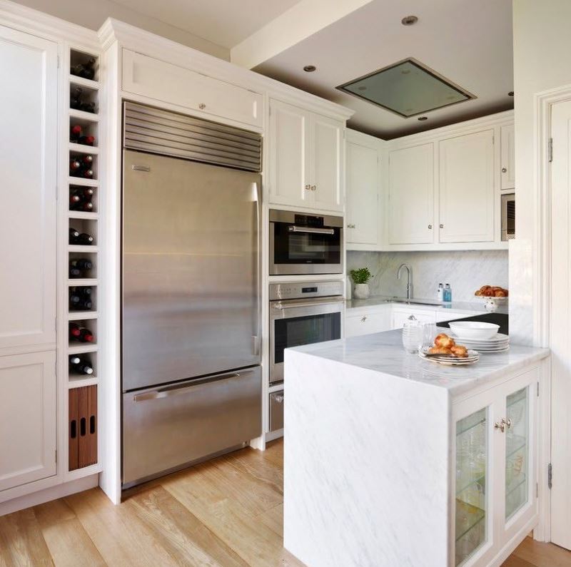 White kitchen and stainless steel fridge