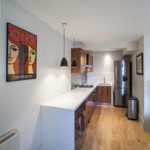 The interior of the elongated kitchen in a modern style