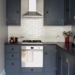 Gray cabinets on the background of a white wall of the kitchen