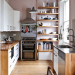 Wooden shelves by the window for kitchen utensils