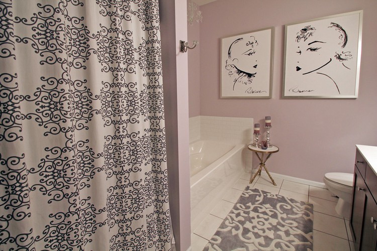 Interior of a modern bathroom with paintings on the wall