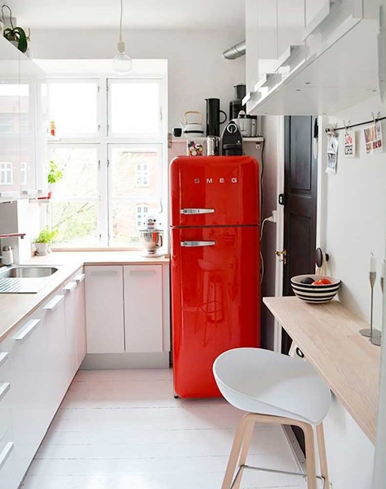 Sarkanā krāsa kā akcents virtuvē ar baltiem skapīšiem