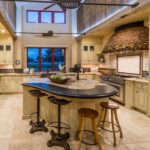 Huge kitchen with an island in the center of the room in a country house