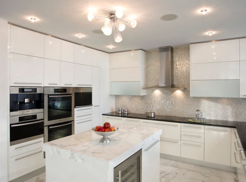 Bright artificial lighting in the kitchen with white furniture