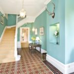 Turquoise walls of the hallway with stairs
