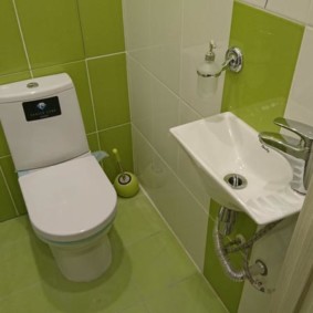 Lime tiles in a small toilet