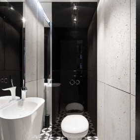 White toilet on a black wall