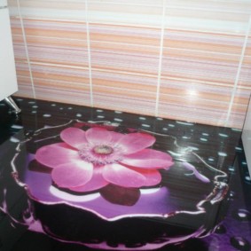 Pink flower on a black bathroom floor