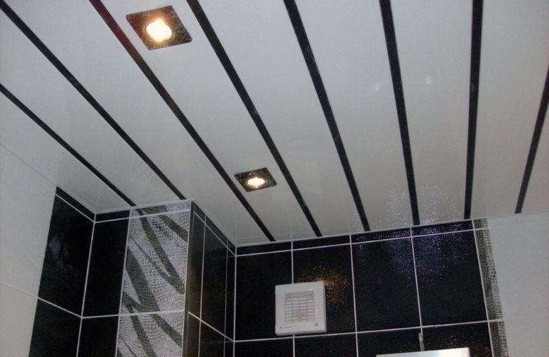 Slatted panels on the ceiling of the bathroom in a city apartment