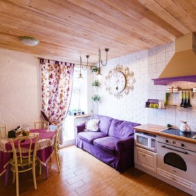 Küçük bir mutfak-oturma odasında ahşap tavan