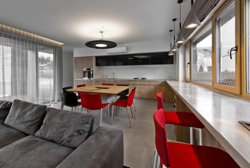 Red chairs near a long countertop