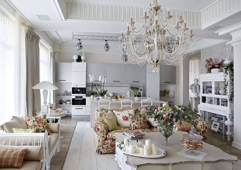 A large chandelier on the ceiling of a Provence-style living room