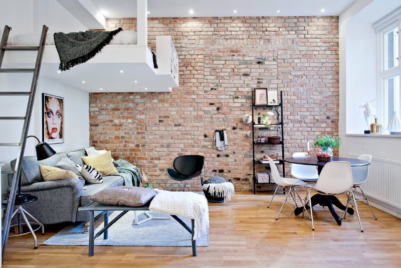 The interior of a studio apartment of 20 sq m in the loft style with a mezzanine