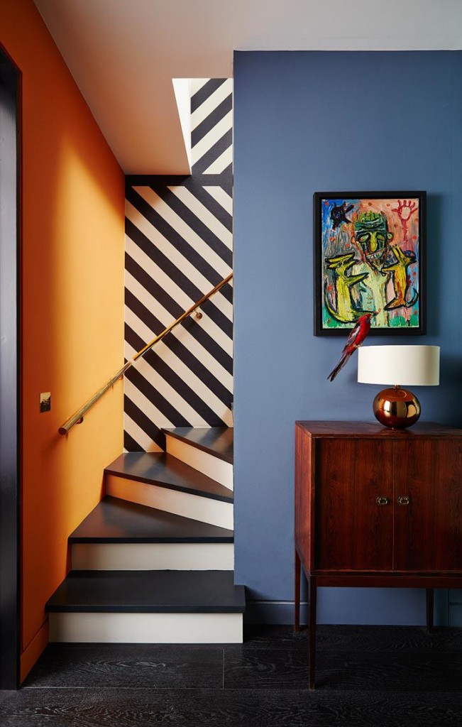 Striped walls in the hallway with stairs.