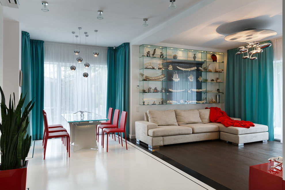 Turquoise curtains made of thick fabric on the window of the kitchen-living room