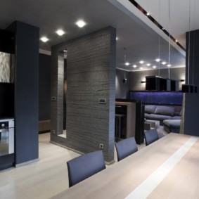 The interior of a studio apartment in gray tones