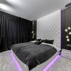 Black curtains in the interior of a modern bedroom