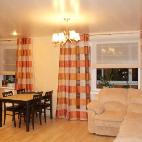 Striped curtains on the windows of the living room kitchen