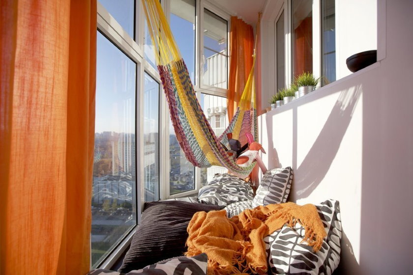 Many pillows on the balcony floor with panoramic windows