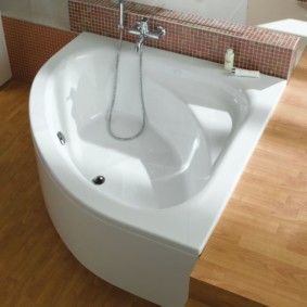 White bath bowl on a wooden floor