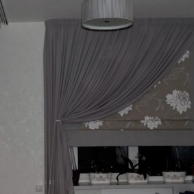 Gray curtain paired with a Roman curtain