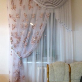 Tulle curtain on one side of the kitchen window