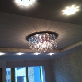 Glass chandelier on a stretch ceiling in the hall