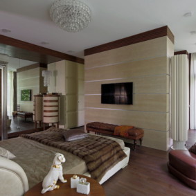 Brown armchair in bedroom with wooden floor