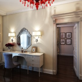 Dressing table in a room with a red chandelier
