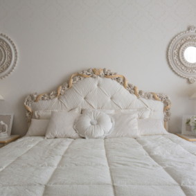 White bed and small mirrors