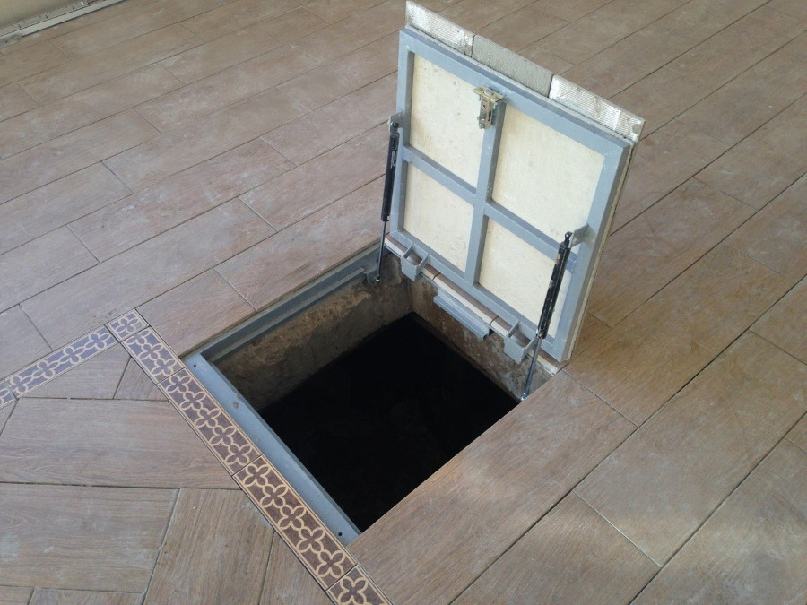 Steel floor hatch in the basement of a private house