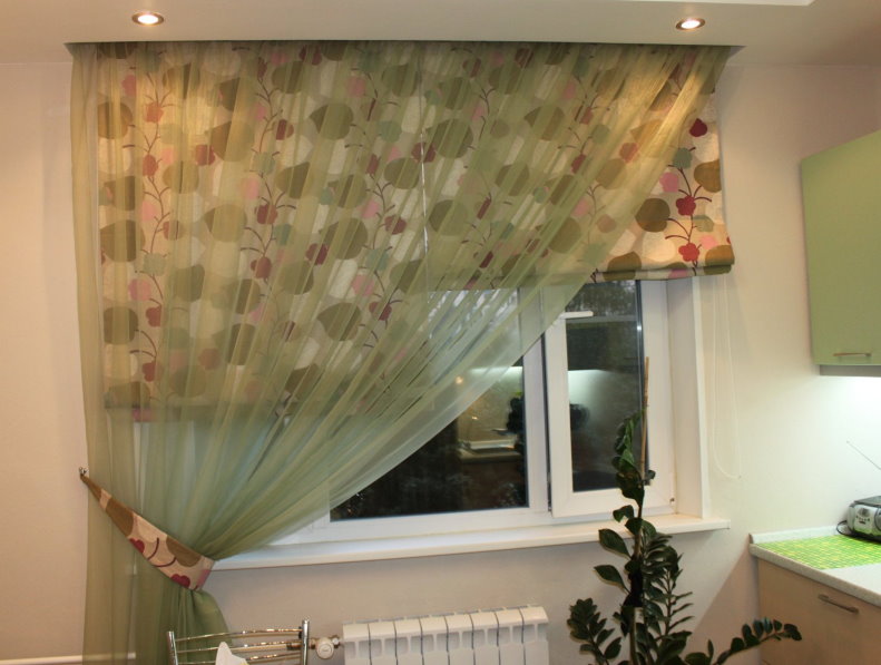 Roman curtains on the kitchen window with an asymmetric curtain