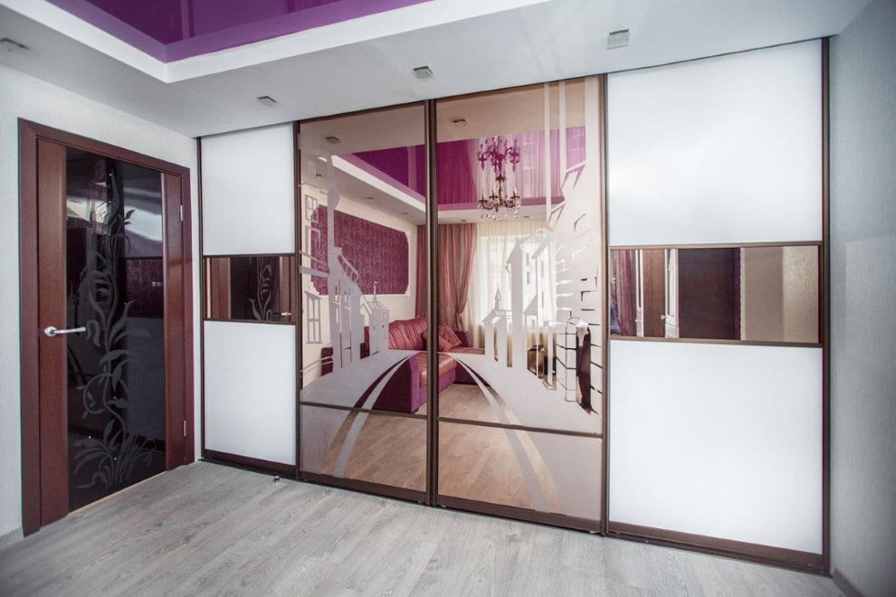 Mirrored doors of the wardrobe in the hall of the apartment
