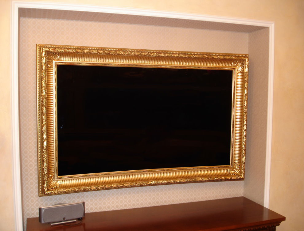 TV in a wooden frame in the wall niche