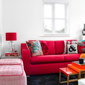 Red furniture in a white living room