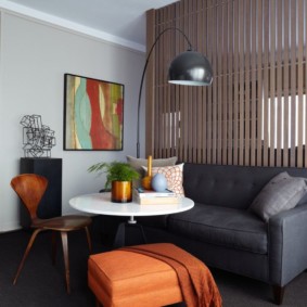 Gray sofa along the wooden partition