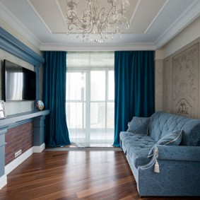 Blue curtains in a room with parquet floor