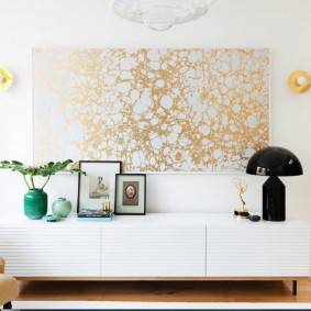 Panel of golden wallpapers on a white wall