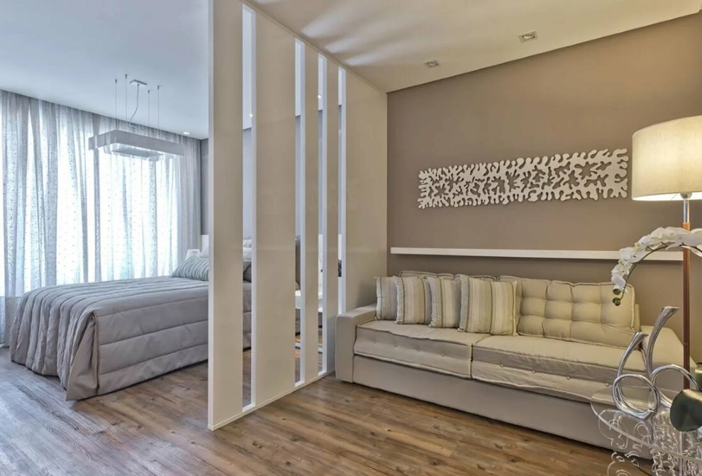 White decorative partition in the hall with a bed