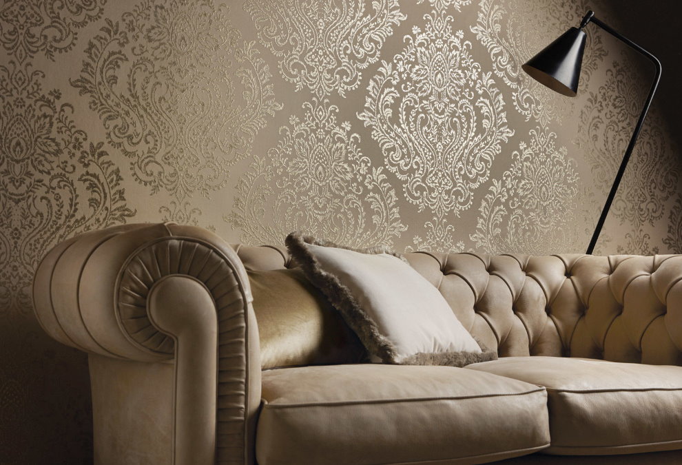 Classic sofa near the wall with fabric wallpaper