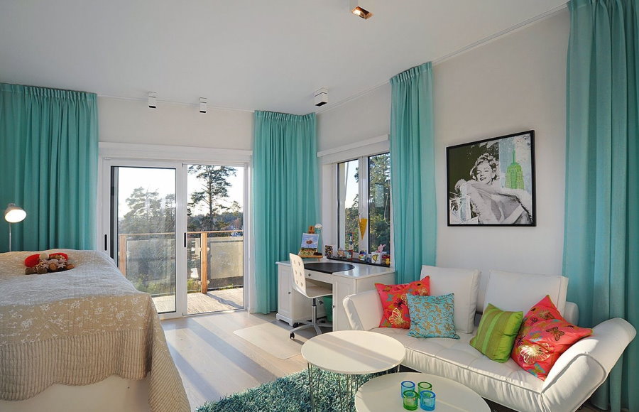 Turquoise curtains on the windows of the living room