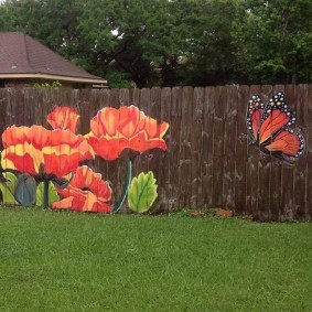 Butterfly and poppies on a wooden fence