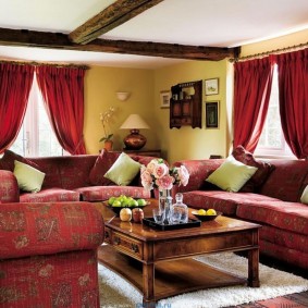 Red curtains in the living room with sofas
