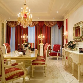 Beige furniture in the hall with burgundy curtains