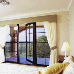 White curtains on the window with a balcony door