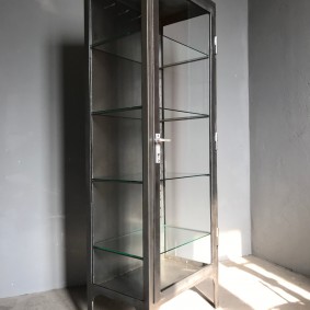 Narrow cabinet with transparent walls for industrial style