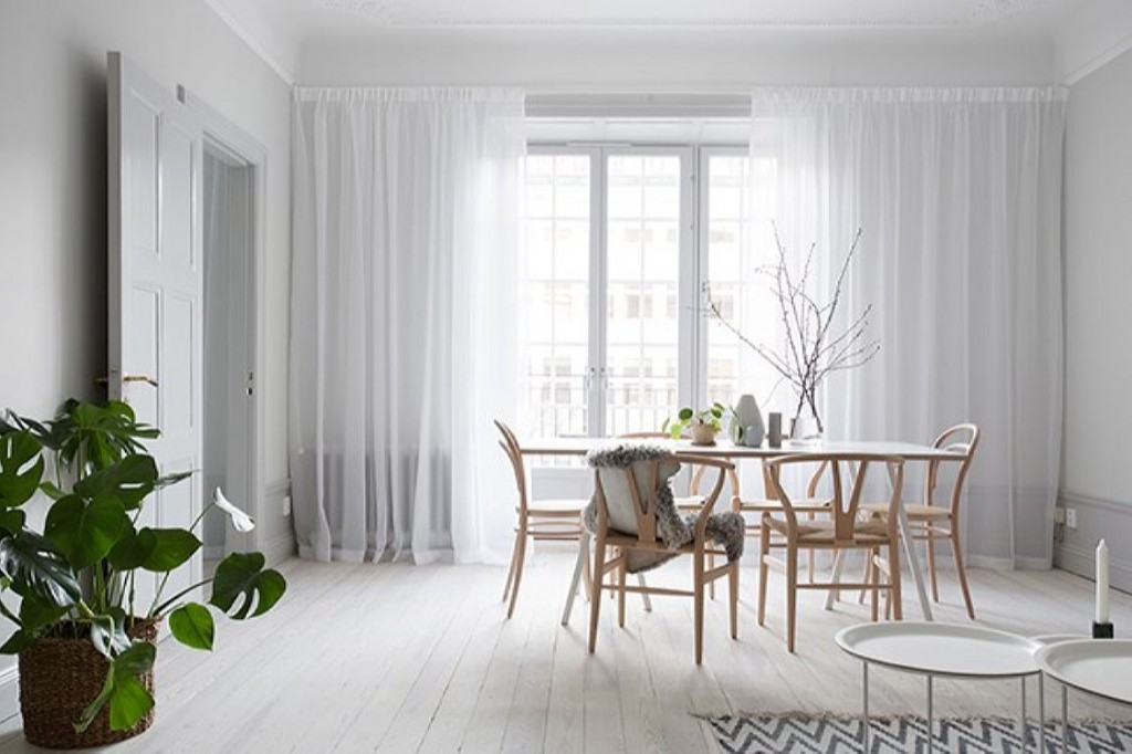 White tulle curtains on a scandi-style living room window